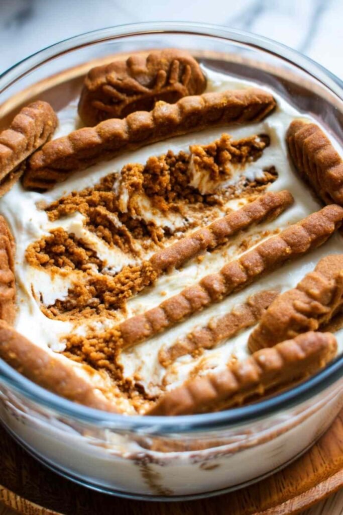 2-ingredient yogurt cheesecake unmolded on a plate topped with fresh berries and honey drizzle