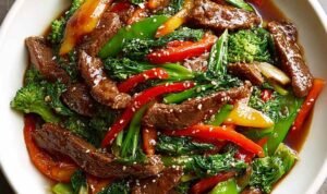 Beef Stir Fry With Vegetables Beef stir fry with vegetables over steamed jasmine rice with green onions and sesame seeds