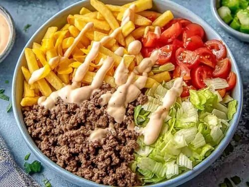 Big Mac bowl with seasoned ground beef, shredded iceberg lettuce, cheddar cheese, and homemade special sauce