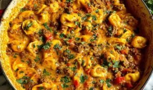 Cheesy One Pot Beef and Potatoes Cheesy one pot beef and potatoes in a nonstick skillet with melted cheddar and fresh parsley