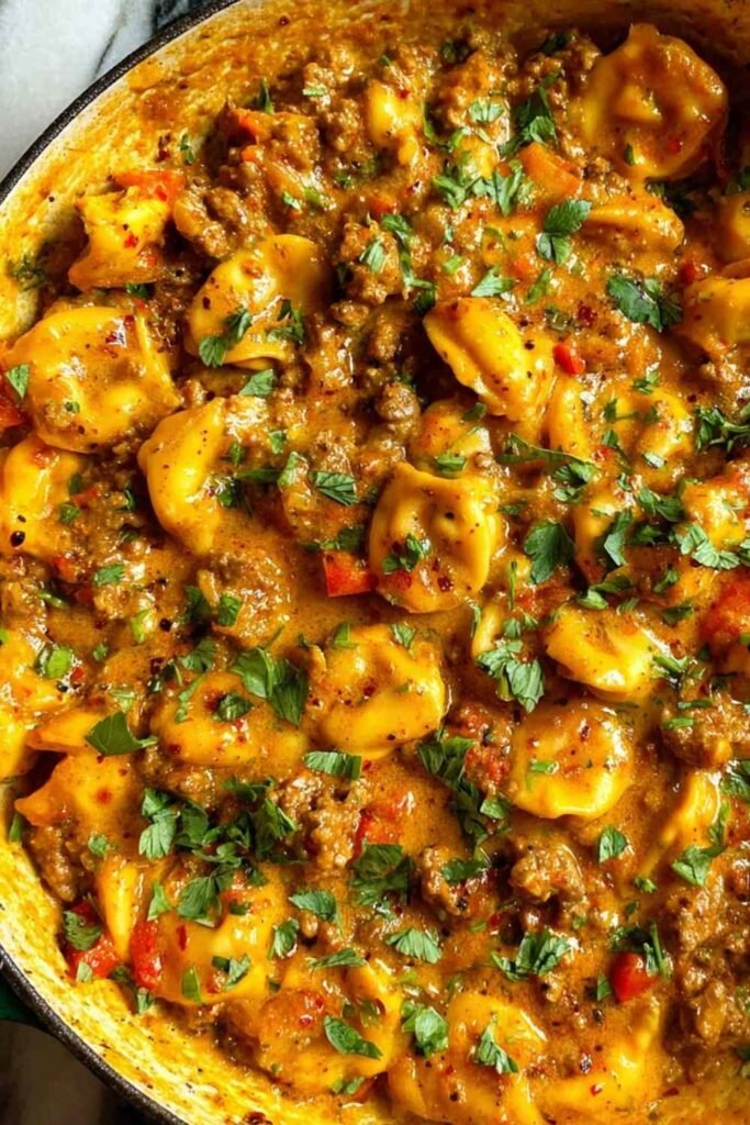 Cheesy one pot beef and potatoes in a nonstick skillet with melted cheddar and fresh parsley