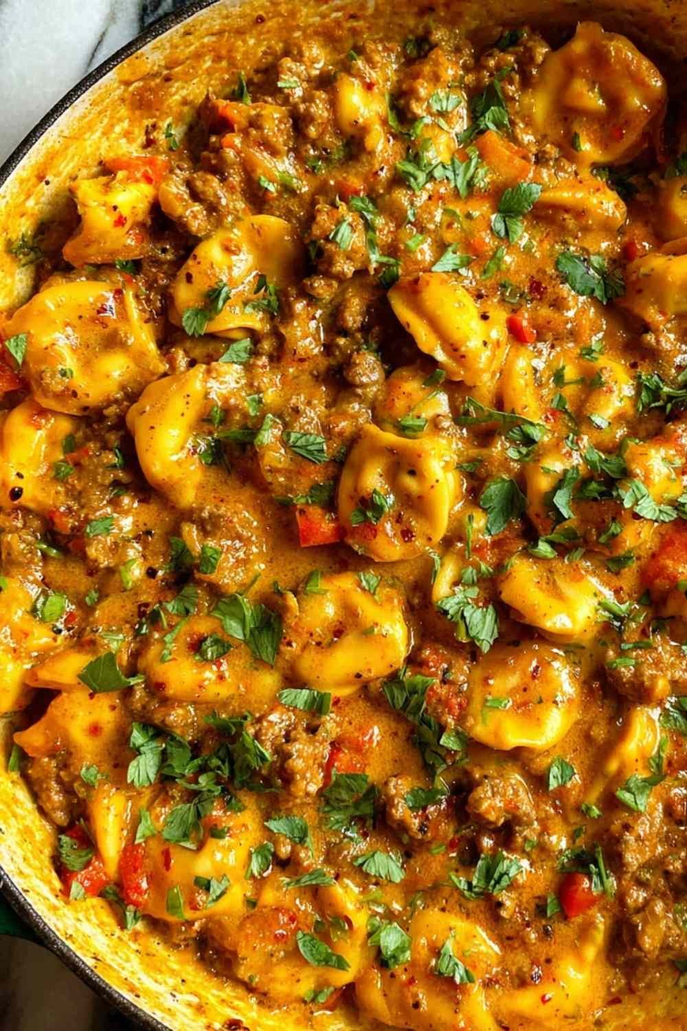 Cheesy one pot beef and potatoes in a nonstick skillet with melted cheddar and fresh parsley