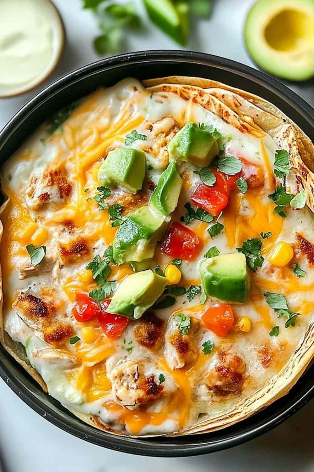 Chicken avocado ranch burritos wrapped and served on a plate with extra ranch dressing on the side