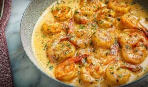 Creamy Garlic Shrimp in a skillet with Parmesan garlic sauce and fresh parsley garnish