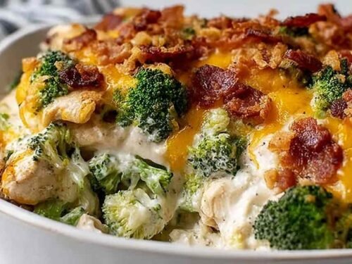 Creamy low carb chicken casserole with broccoli and bacon topped with golden melted cheddar and mozzarella in a 9x13 baking dish