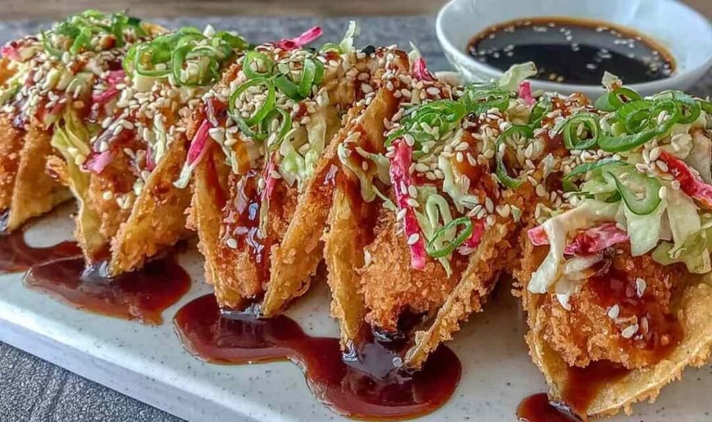 Crispy chicken wonton tacos with teriyaki glaze on white plate showing golden wonton shells with chicken and toppings