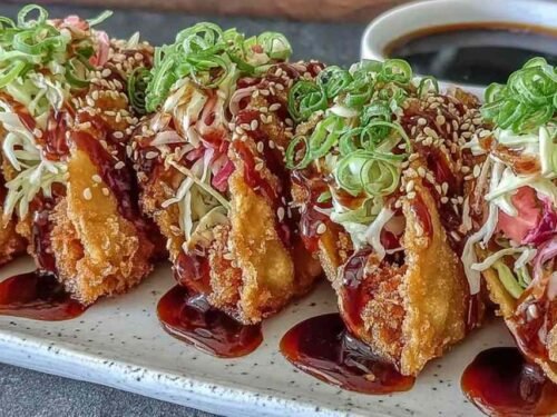 Crispy chicken wonton tacos with teriyaki glaze on white plate showing golden wonton shells with chicken and toppings