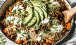 Ground Beef Enchilada Skillet Ground Beef Enchilada Skillet in a large pan topped with sliced avocado, fresh cilantro, and dairy-free sour cream ready to serve