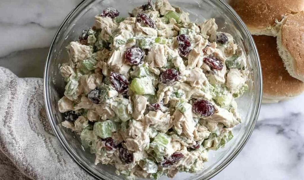 Healthy chicken salad no mayo in bowl with Greek yogurt, grapes, walnuts and fresh herbs
