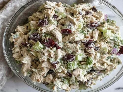 Healthy chicken salad no mayo in bowl with Greek yogurt, grapes, walnuts and fresh herbs