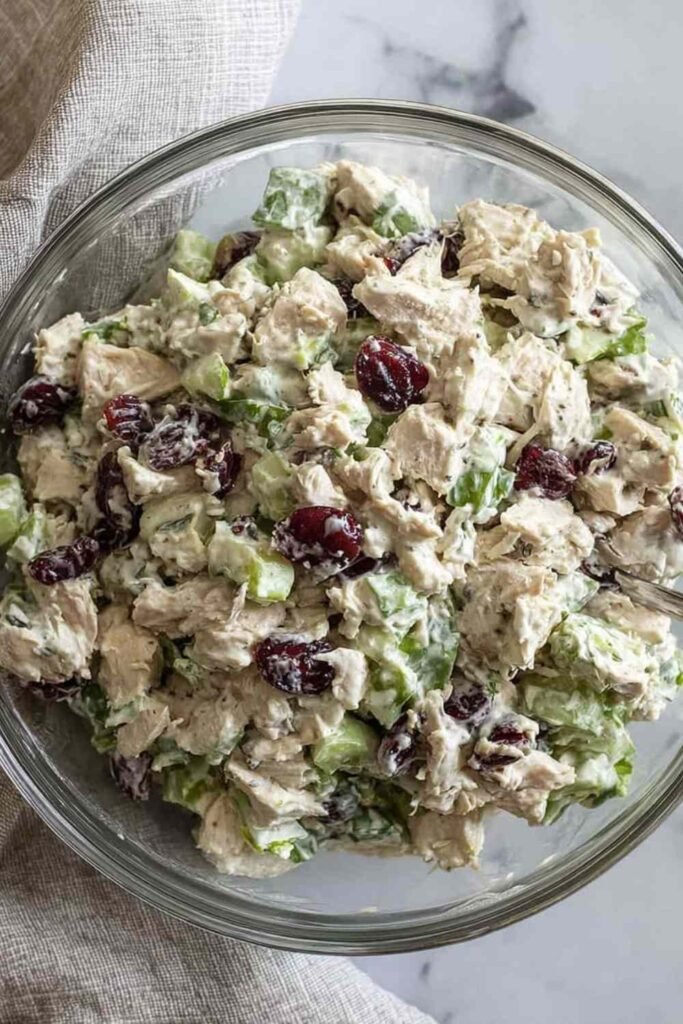 Healthy chicken salad no mayo in bowl with Greek yogurt, grapes, walnuts and fresh herbs