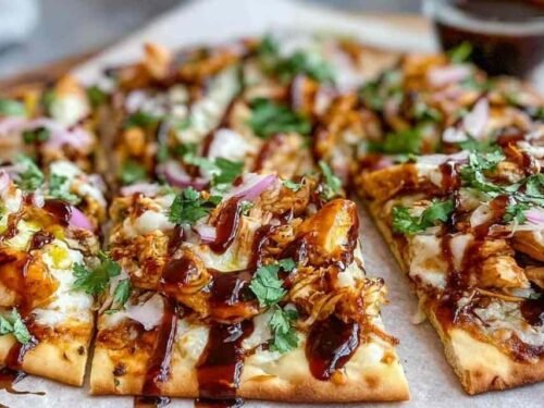 BBQ chicken flatbread with melted Colby Jack cheese bell peppers and green onions on baking sheet