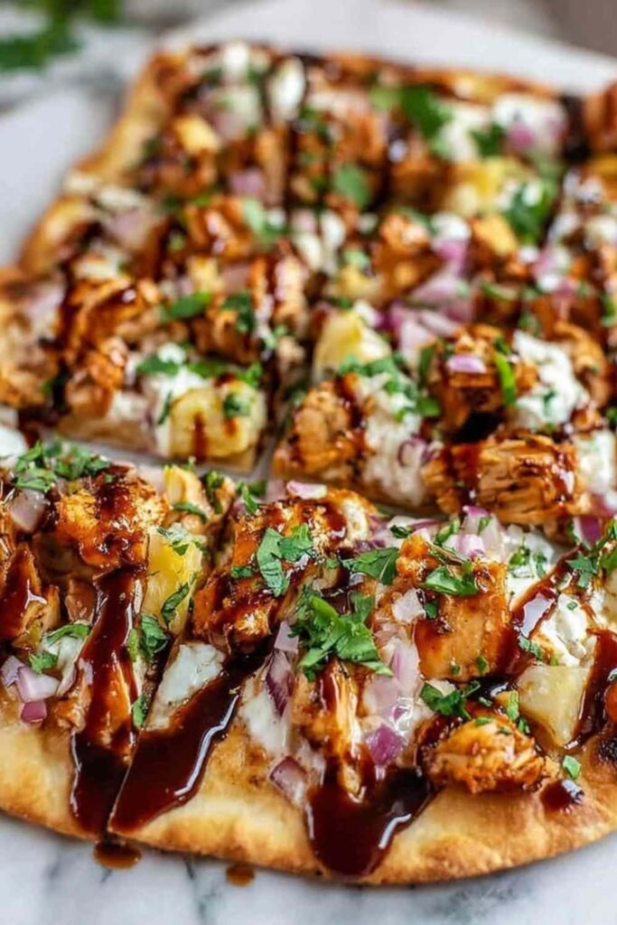 BBQ chicken flatbread with melted Colby Jack cheese bell peppers and green onions on baking sheet