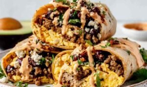 High Protein Breakfast Burrito High protein breakfast burrito wrapped in aluminum foil on a baking sheet ready for the freezer