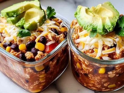 High-protein chicken cottage cheese enchilada bowl topped with avocado, cilantro, and Greek yogurt
