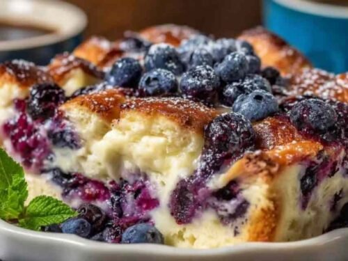 Blueberry cottage cheese breakfast bake golden brown in square baking dish with visible blueberries and oats