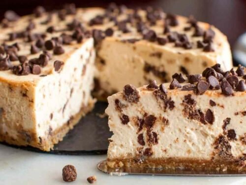 Creamy protein cheesecake slice on a white plate with fresh berry topping