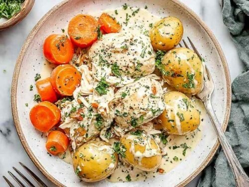 Ranch chicken and veggies with cottage cheese in slow cooker showing shredded chicken, potatoes, and carrots in creamy ranch sauce