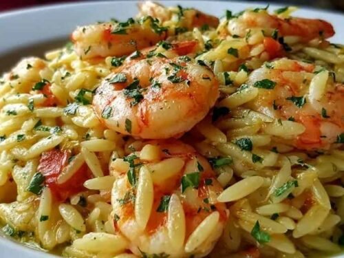 Shrimp orzo lemon garlic sauce in a skillet with pink seared shrimp, tender orzo, and fresh parsley