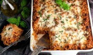 Southern Baked Spaghetti Casserole Southern baked spaghetti casserole in 9x13 baking dish with golden melted mozzarella and herb-seasoned meat sauce