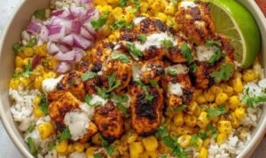 Street Corn Chicken Rice Bowl Street corn chicken rice bowl with charred corn, juicy chicken breast, diced avocado, Cotija cheese, and fresh cilantro over brown rice