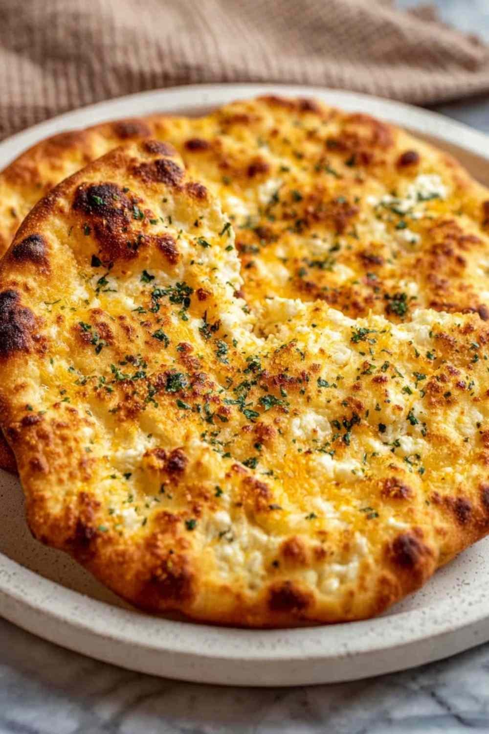 Golden-edged viral cottage cheese flatbread on a parchment-lined baking sheet just out of the oven with a matte fully set surface