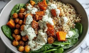 Anti-inflammatory glow bowl with quinoa, roasted sweet potatoes, crispy chickpeas, avocado, and tahini yogurt sauce
