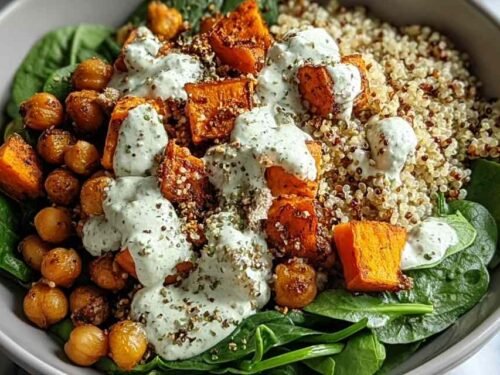 Anti-inflammatory glow bowl with quinoa, roasted sweet potatoes, crispy chickpeas, avocado, and tahini yogurt sauce