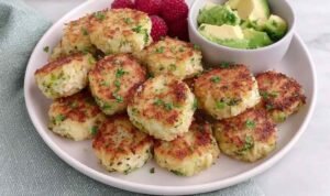 Homemade chicken and broccoli nuggets for baby arranged on a white plate, golden and ready to serve