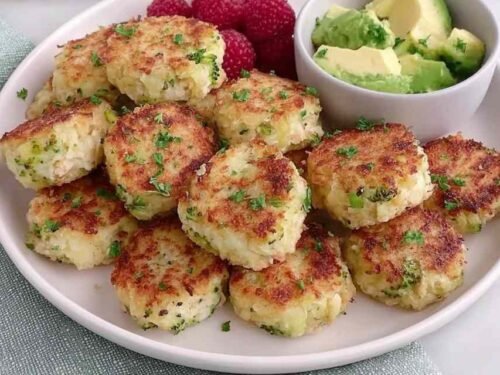 Homemade chicken and broccoli nuggets for baby arranged on a white plate, golden and ready to serve