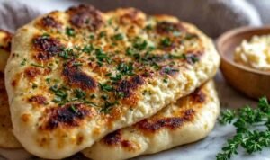 Healthy cottage cheese flatbread on a parchment-lined baking tray with golden edges and firm center fresh from the oven