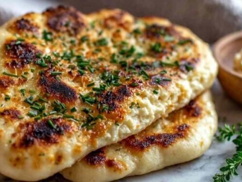Healthy cottage cheese flatbread on a parchment-lined baking tray with golden edges and firm center fresh from the oven