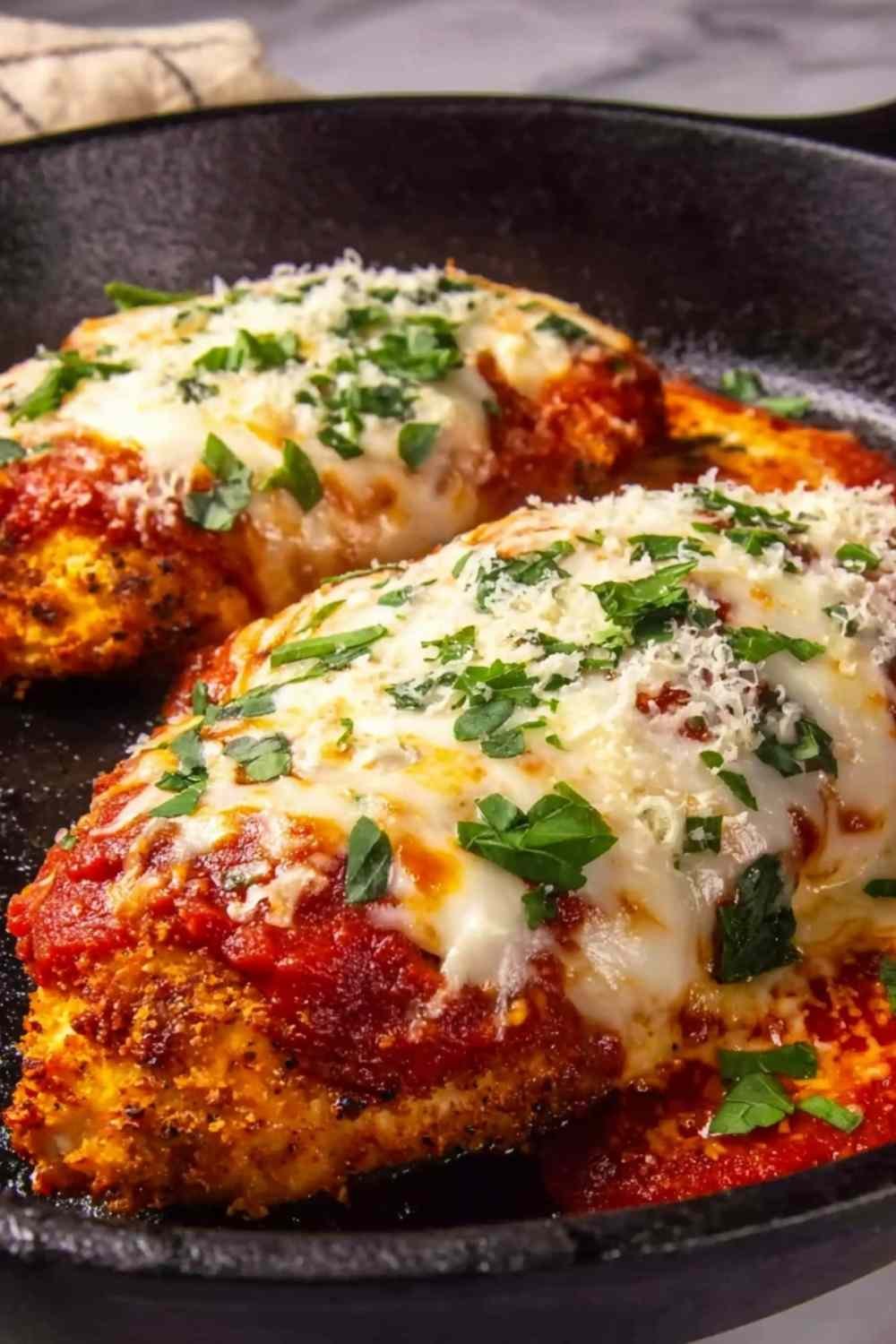 High-protein chicken parm topped with golden melted cheese and marinara sauce in a baking dish