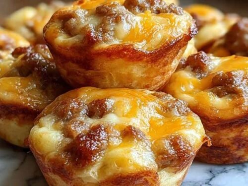 Golden high-protein pancake sausage mini muffins cooling on a wire rack after baking