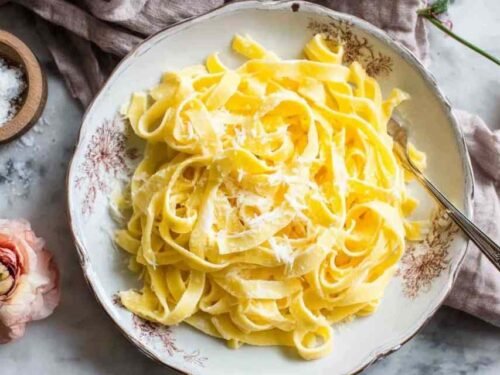 Homemade keto egg noodles made with almond flour served in a white bowl