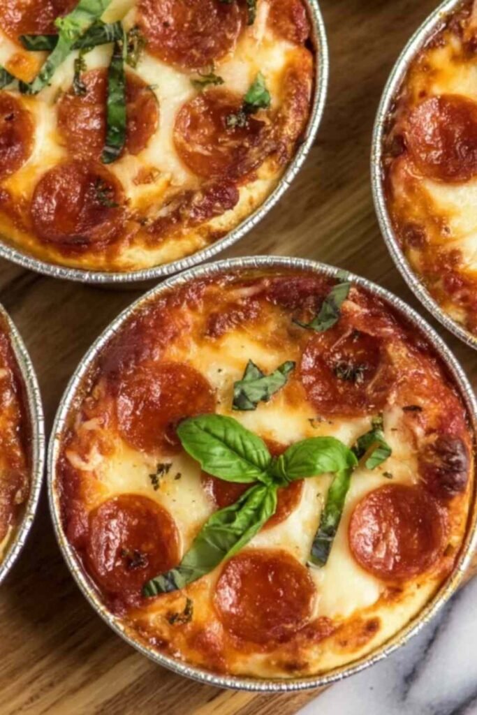 Individual Pizza Pot Pies baked in ramekins with a golden flaky crust and bubbling melted mozzarella cheese