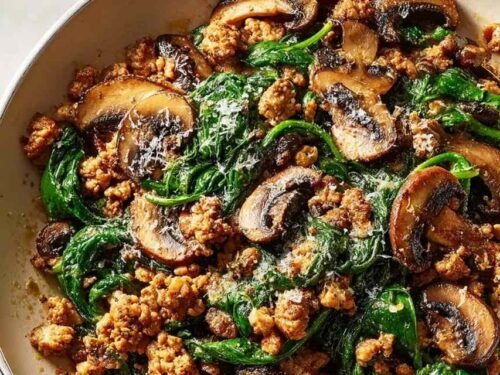 Turkey Spinach Mushroom Skillet with creamy Parmesan sauce, crumbled ground turkey, and wilted spinach in a large skillet